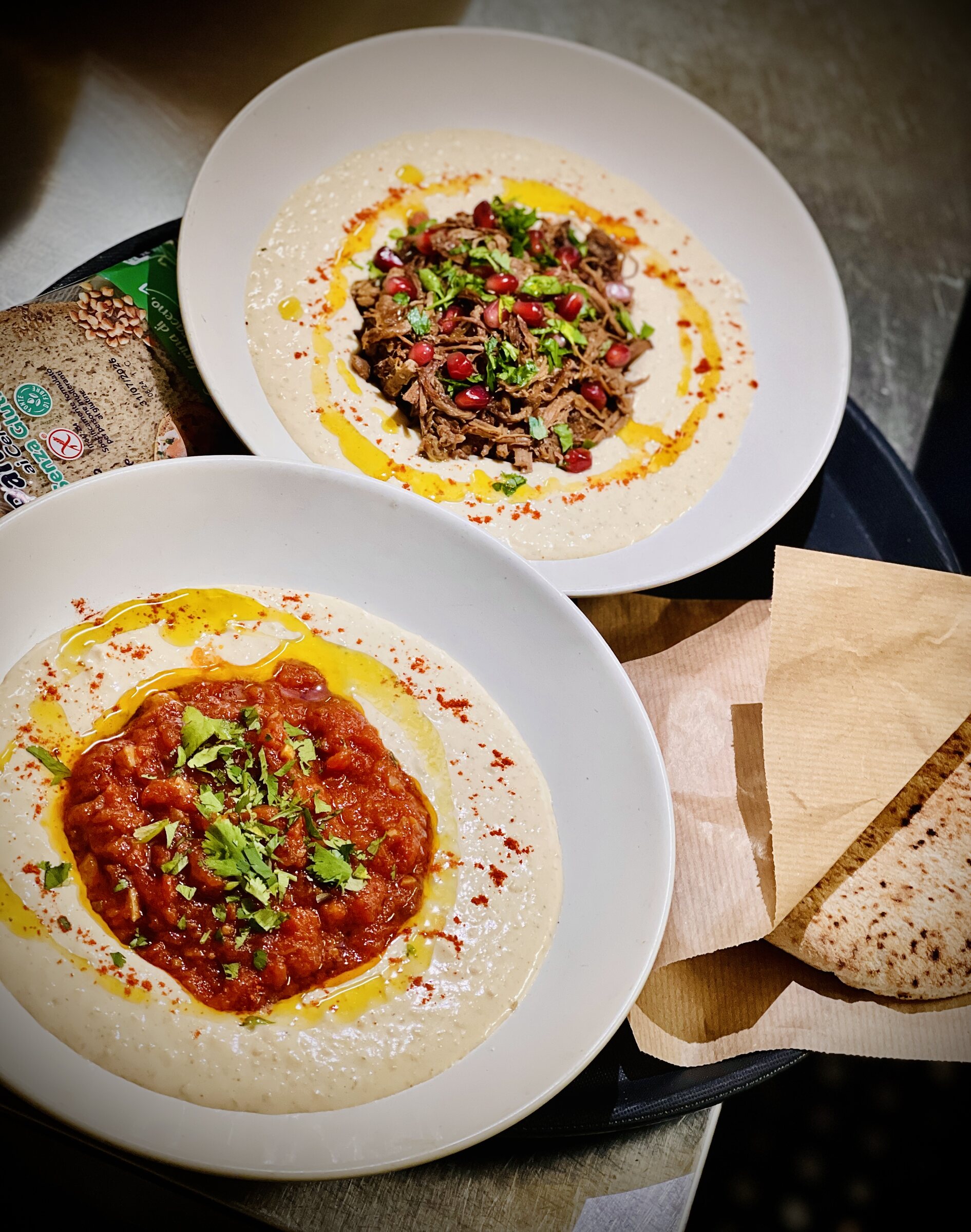 Hummus, dishes and pita bread at Yallah