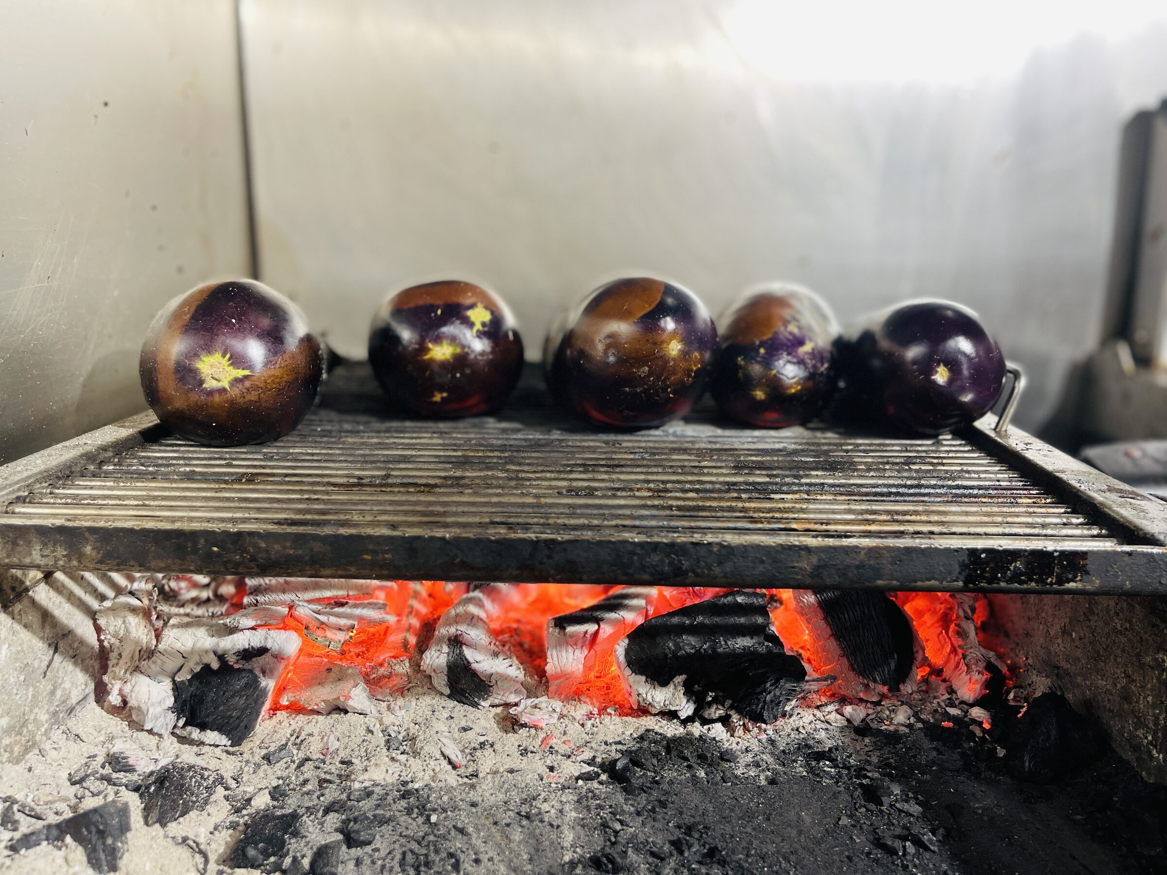 Aubergines over the coals.