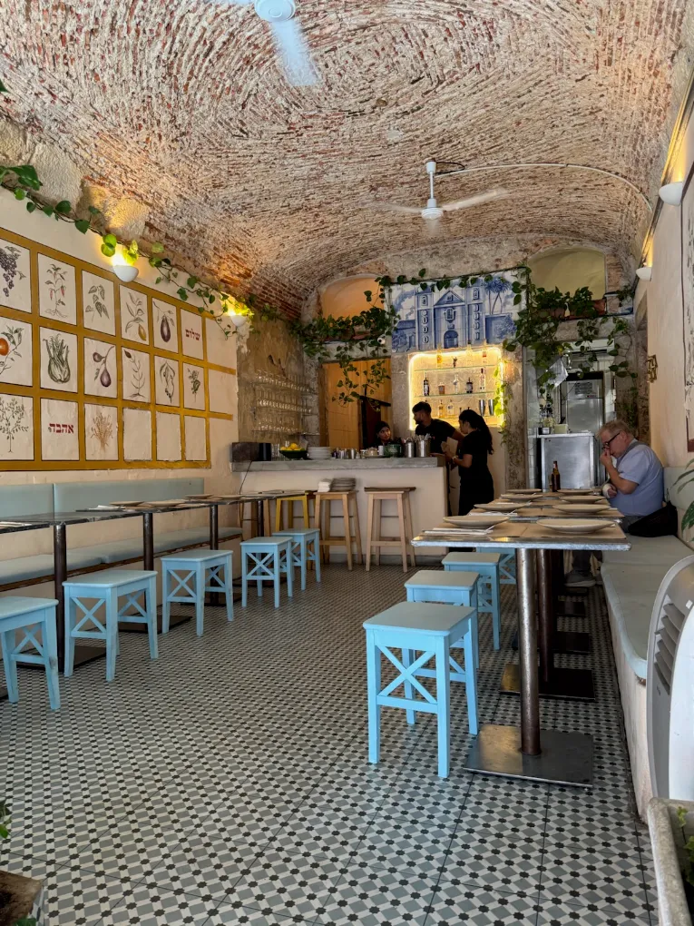 Tables and blue stools in Yallah’s dining room
